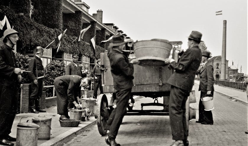 NSB-ers worden in mei 1945 door leden van de Binnenlandse Strijdkrachten verplicht om huisvuil op te halen (foto: Henk J. Janszen).
