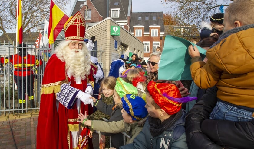 <p>Sinterklaas schudt kinderhanden tijdens de intocht van vorig jaar.</p>