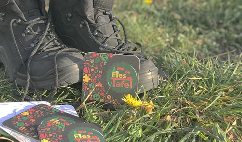 <p>Wandelschoenen en de bekende bierviltjes voor de antwoorden. </p>