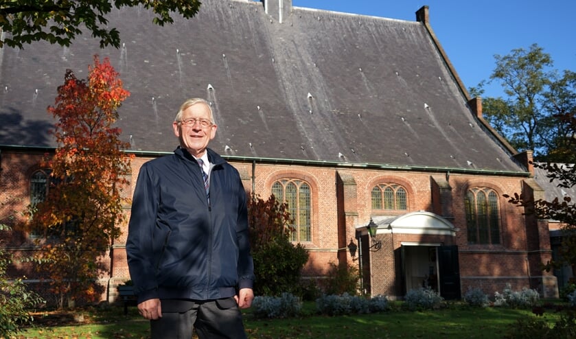 Dick de Boer bij de Dorpskerk, die een belangrijke rol speelt in het boek. | Foto: C. v.d. Laan
