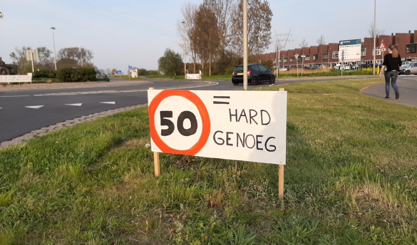 De omwonenden van de zuidkant van de Oude Spoorbaan maken hun mening duidelijk met borden in de berm van de weg.
