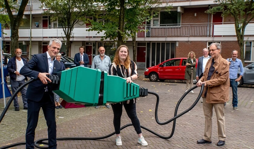 Gedeputeerde Berend Potjer (GroenLinks) verricht samen met bewoners Mariëlle van Gijzen en Egbert Boonstra de openingshandeling voor de zonnestroominstallatie aan de Langedijkdreef.
