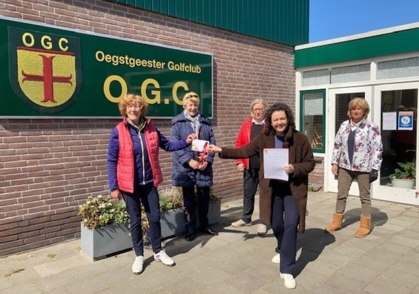 <p>De 'oma's' van de golfclub overhandigen de cheque.</p>