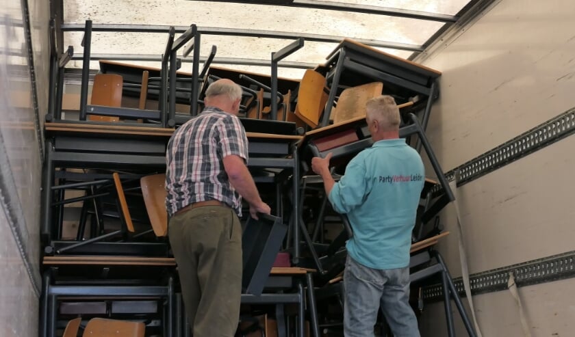 <p>Passen en meten om het schoolmeubilair in de vrachtwagen te krijgen. | Foto: Aart Broek</p>